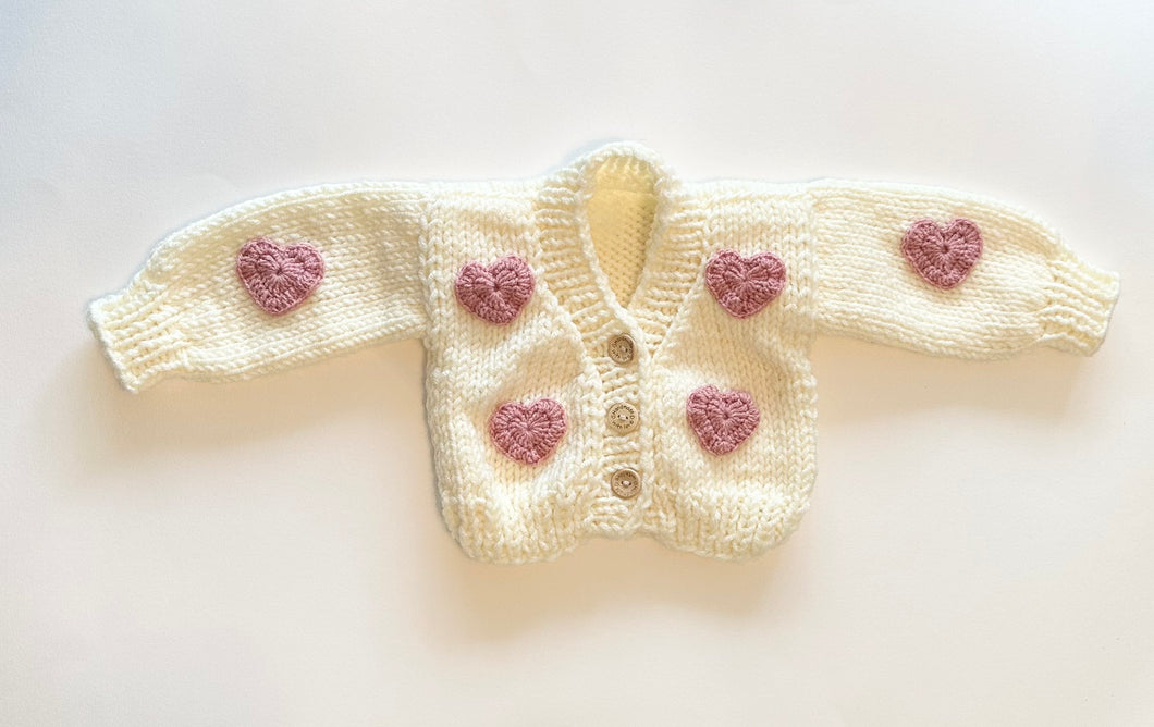 Chunky white cardigan with pink hearts