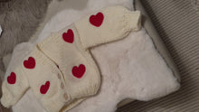 Load and play video in Gallery viewer, Chunky white cardigan with red hearts
