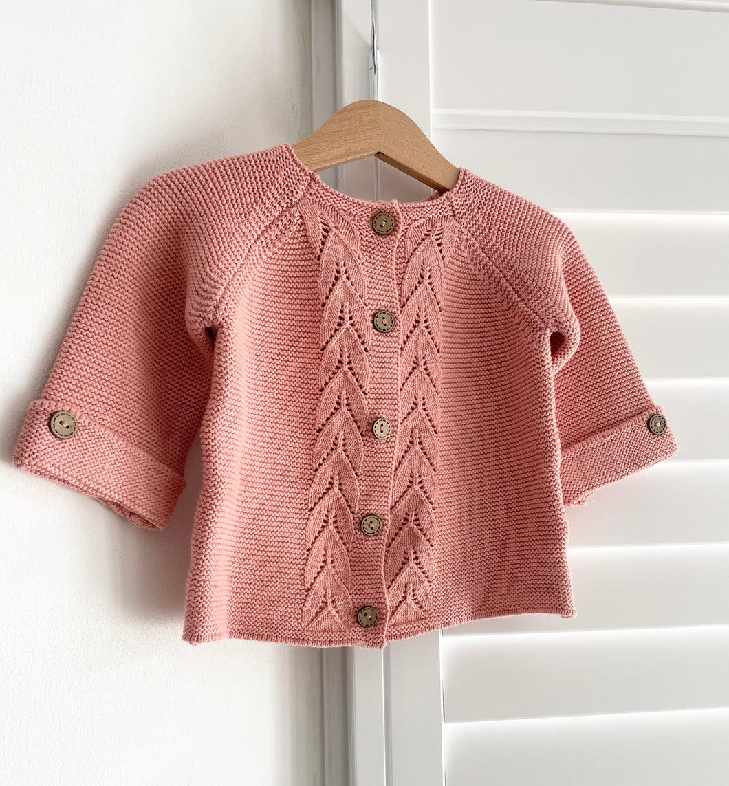 Pink knitted cardigan in a peachy pink