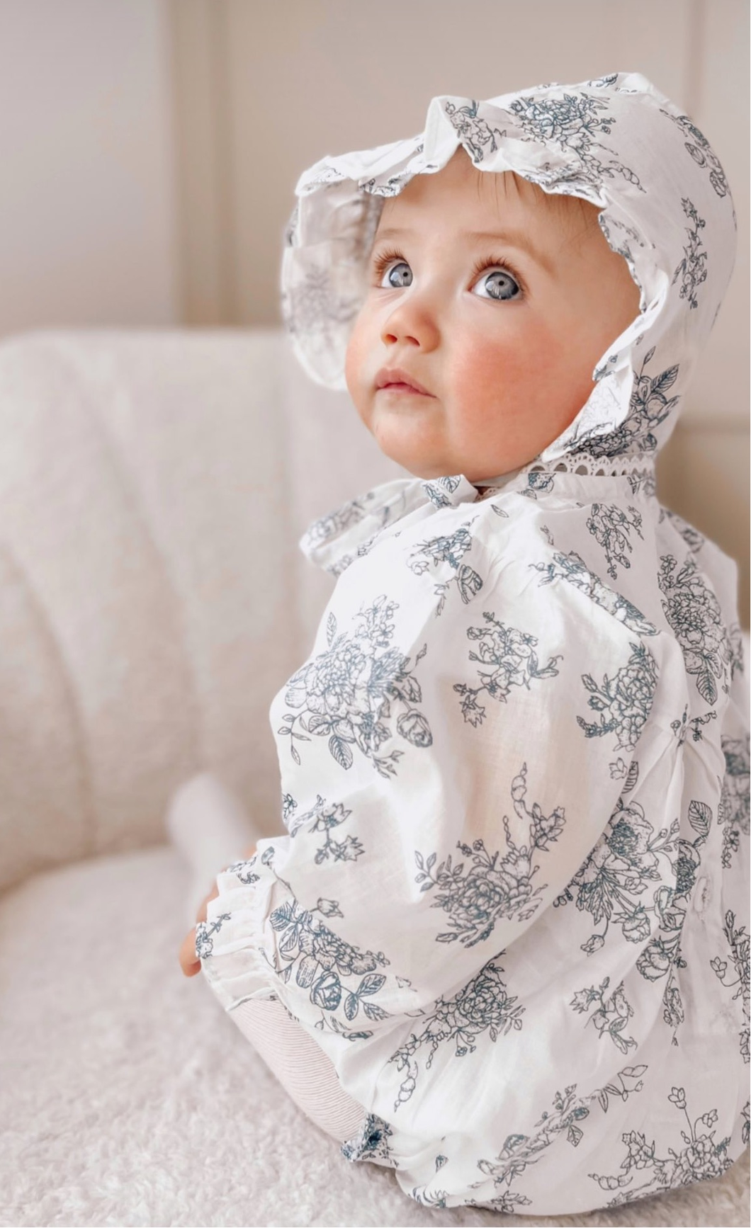 Blue long sleeved floral romper with lace trim